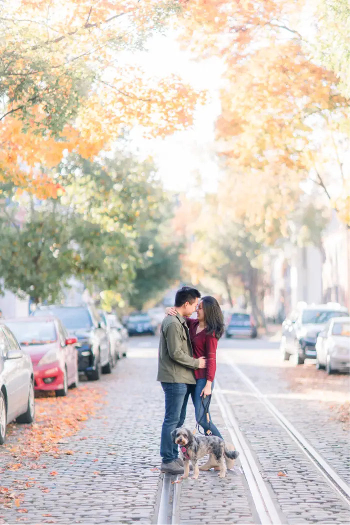 The couple embracing on a leafy Georgetown street with their dog by their side.