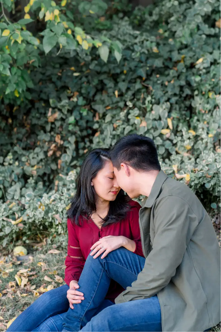 The couple laying on the grass next to each other.