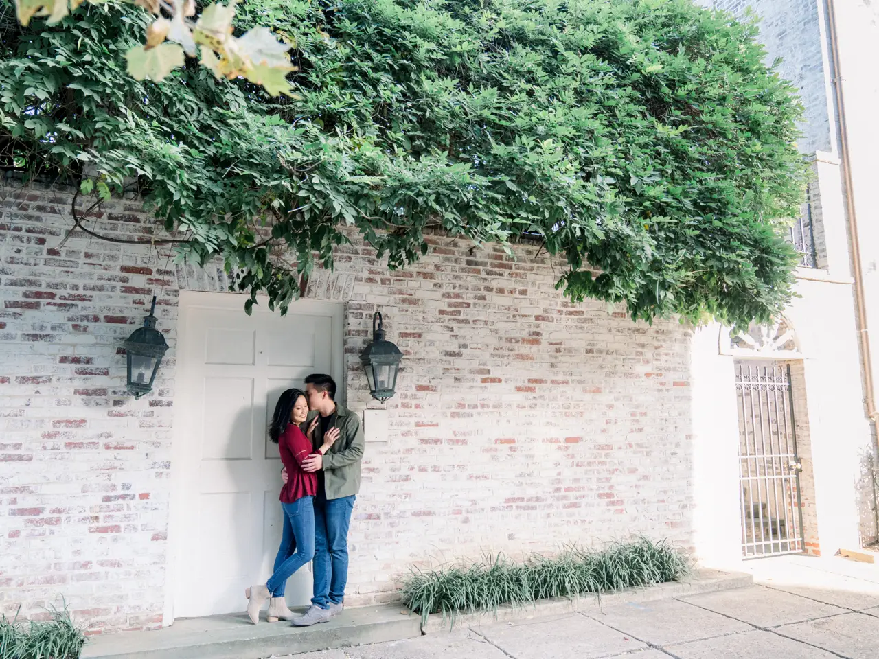 The couple embracing in the doorway of a Victorian style home in Georgetown.